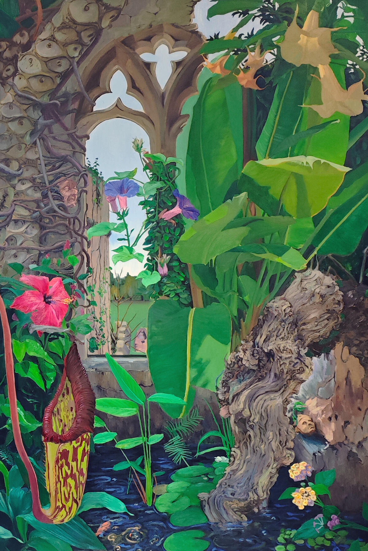 Large oil painting titled Manifestation by artist James, 180 × 90 cm. Depicts lush tropical growth emerging through the Gothic ruins of Torre Abbey, with banana leaves, trumpet flowers, and a pool of water beneath carved stone arches.